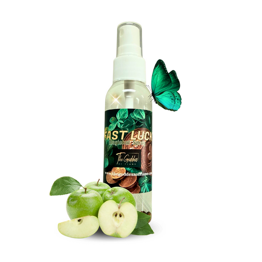 Bottle of Fast Luck Spray with bay leaves, crystals, and gold coins on ritual altar